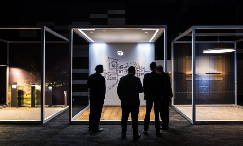 Three men observing an art piece