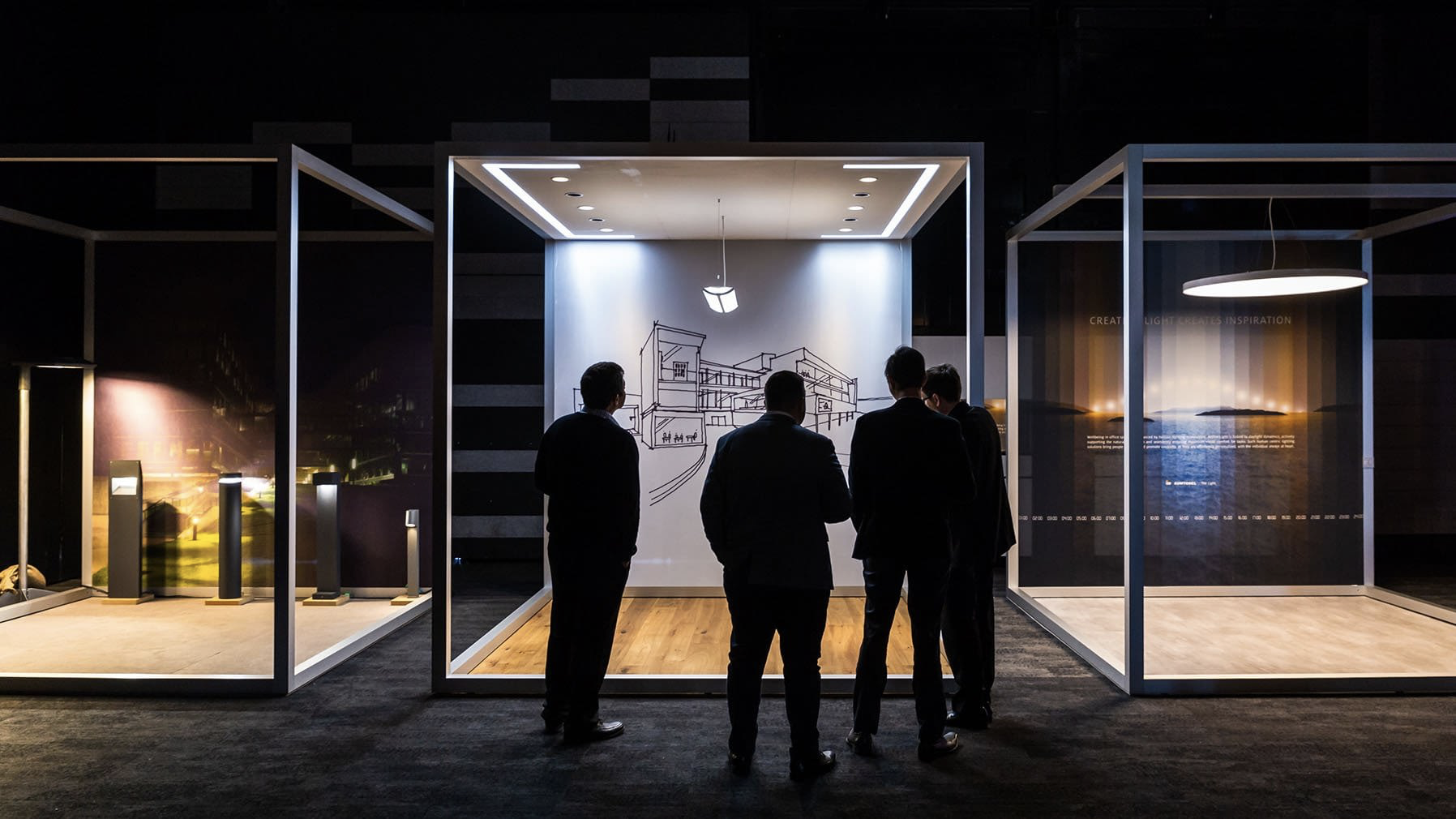 Three men observing an art piece