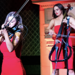 two female musicians performing on a stage