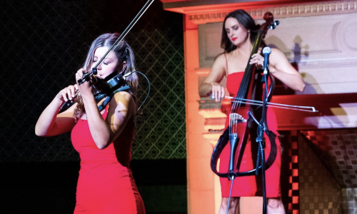 two female musicians performing on a stage