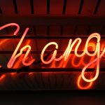 a neon sign that says change