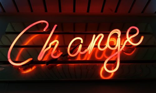 a neon sign that says change